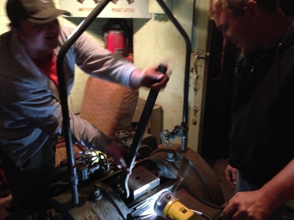 X-5000 volunteer Brian LaKemper (left) and Jeron Glander (right) work on the dynamometer unit. 9/14/13.